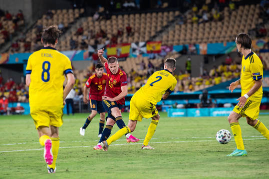 Dani Olmo of Spain and Mikael Lustig of Sweden