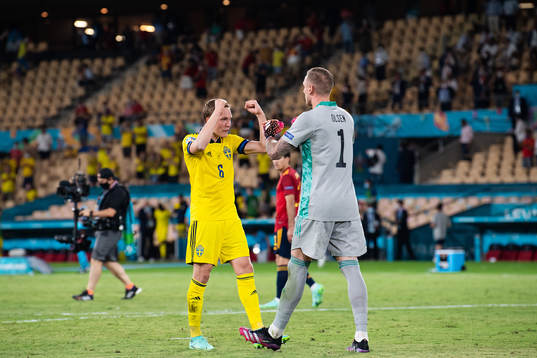 Ludwig Augustinsson and goalkeeper Robin Olsen celebrate