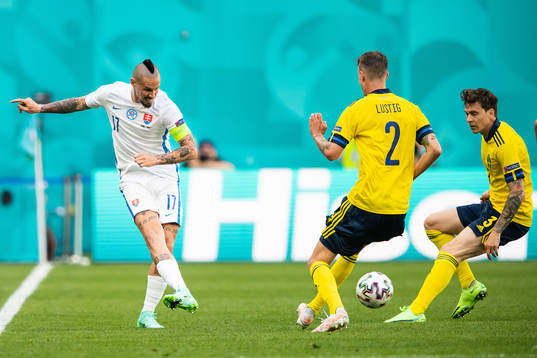 Marek Hamsik of Slovakia against Mikael Lustig and Victor