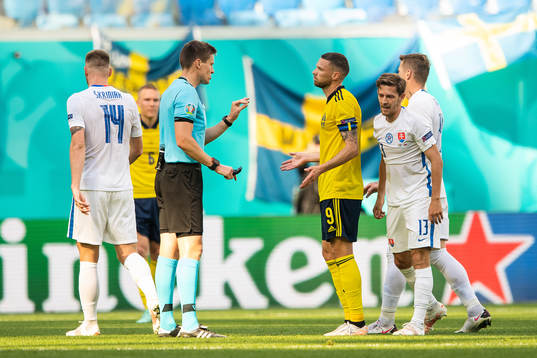 referee Daniel Siebert and Marcus Berg of Sweden