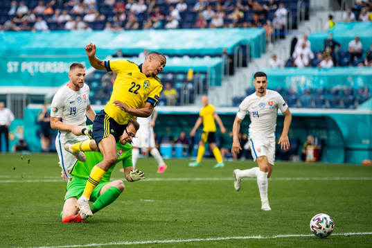 Robin Quaison of Sweden and goalkeeper Martin Dubravka