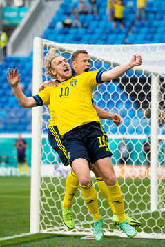 Emil Forsberg and Viktor Claesson of Sweden celebrate