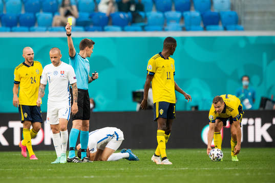 referee Daniel Siebert shows a yellow card to Viktor