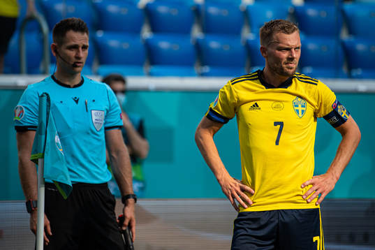 A linesman and Sebastian Larsson of Sweden