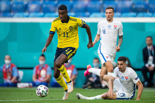 Alexander Isak of Sweden dribbles past Martin Koscelnik of