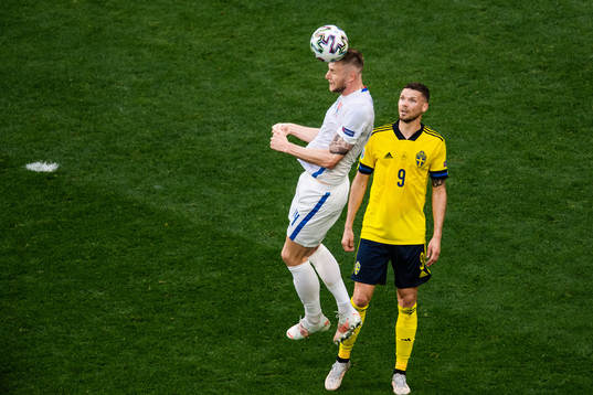Milan Skriniar of Slovakia and Marcus Berg of Sweden