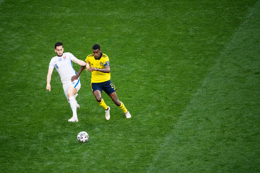 David Hancko of Slovakia and Alexander Isak of Sweden