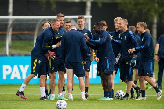 Players of Sweden joking with Emil Krafth of the Swedish