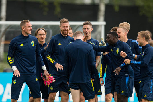 Players of Sweden joking with Emil Krafth of the Swedish