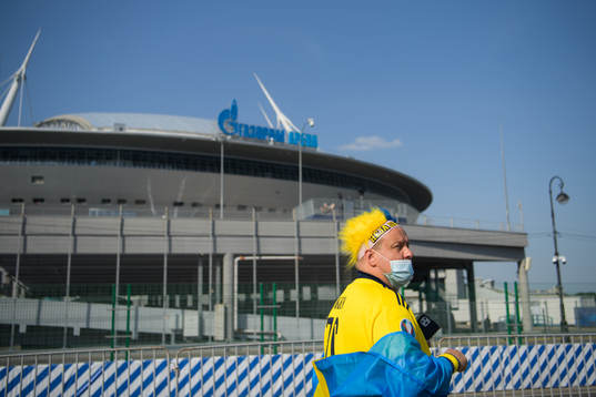 A Swedish fan walks past Saint Petersburg Stadium