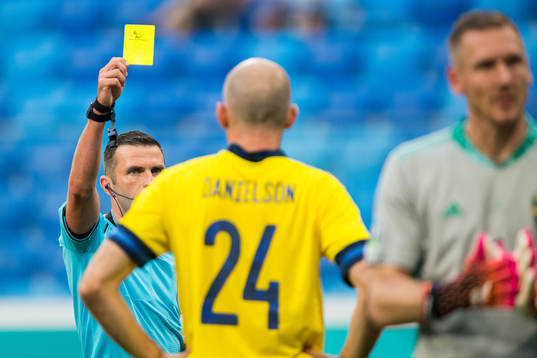 Marcus Danielson of Sweden is shown a yellow card by