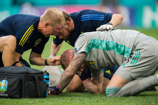 Goalkeeper Robin Olsen of Sweden in pain