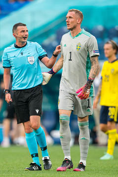 Referee Michael Oliver and goalkeeper Robin Olsen of Sweden