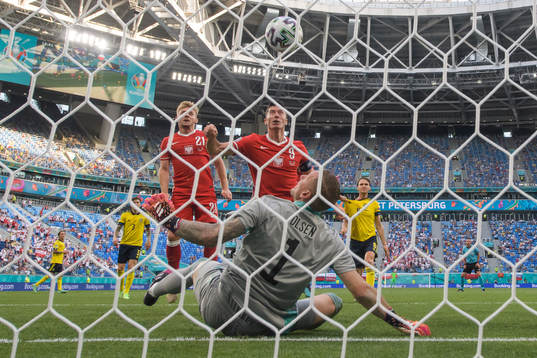 Robert Lewandowski of Poland attacks in front of goalkeeper
