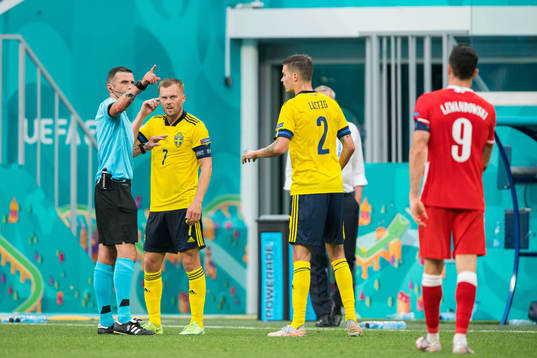 Referee Michael Oliver with Sebastian Larsson and Mikael