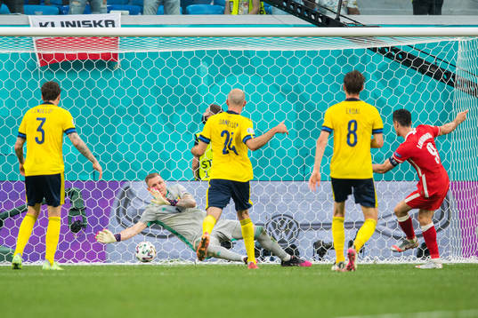 Robert Lewandowski of Poland scores the 2-2 goal against