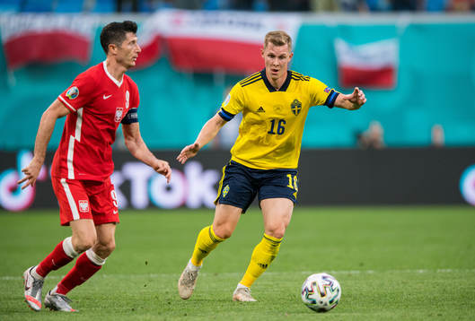 Robert Lewandowski of Poland and Emil Krafth of Sweden