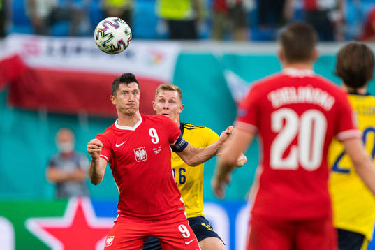 Robert Lewandowski of Poland and Emil Krafth of Sweden