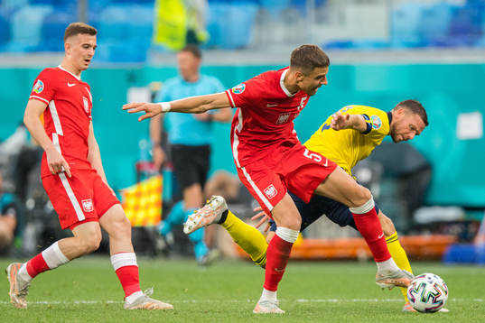 Jan Bednarek of Poland and Marcus Berg of Sweden