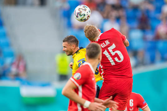 Marcus Berg of Sweden and Kamil Glik of Poland