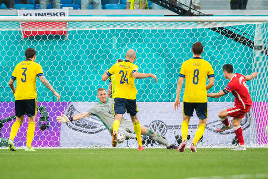 Robert Lewandowski of Poland scores 2-2 against. goalkeeper
