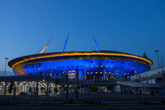 Saint Petersburg Stadium is lighted up in yellow and blue