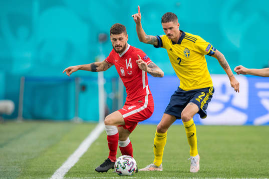 Mateusz Klich of Poland and Mikael Lustig of Sweden