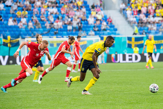 Alexander Isak of Sweden and Kamil Glik of Poland