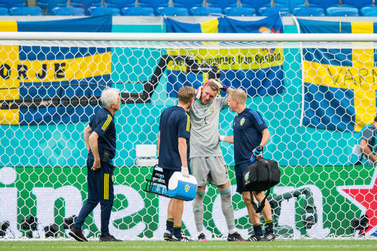 Goalkeeper Robin Olsen of Sweden in pain