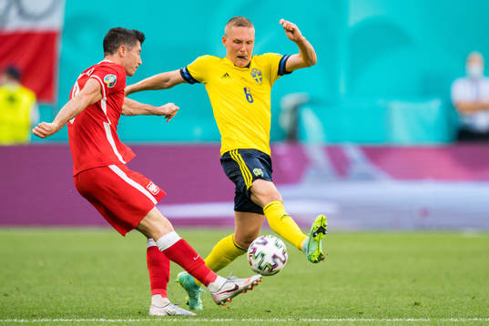 Robert Lewandowski of Poland and Ludwig Augustinsson of