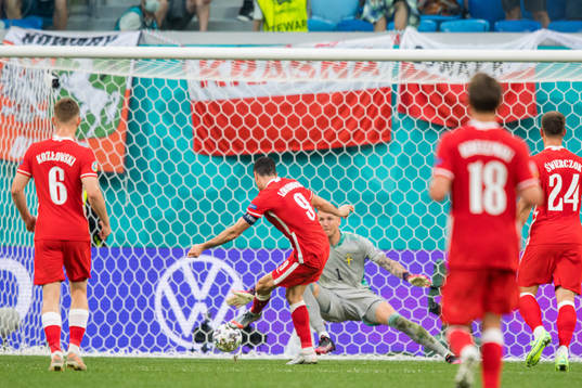 Robert Lewandowski of Poland scores 2-2 against goalkeeper
