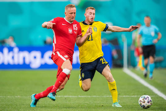 Kamil Glik of Poland and Dejan Kulusevski of Sweden