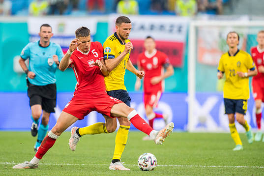Jan Bednarek of Poland and Marcus Berg of Sweden