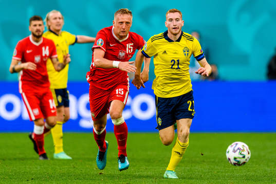 Kamil Glik of Poland and Dejan Kulusevski of Sweden