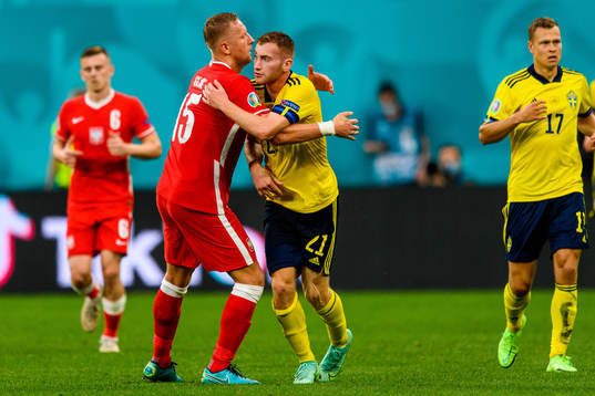 Dejan Kulusevski of Sweden and Kamil Glik of Poland