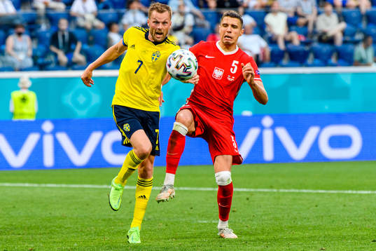 Sebastian Larsson of Sweden and Jan Bednarek of Poland