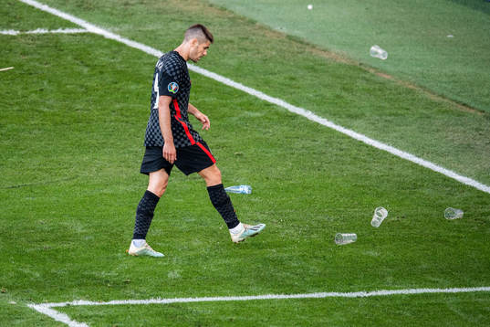 Andrej Kramaric of Croatia kicks away cops from the pitch
