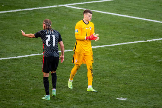 Domagoj Vida and goalkeeper Dominik Livakovic of Croatia