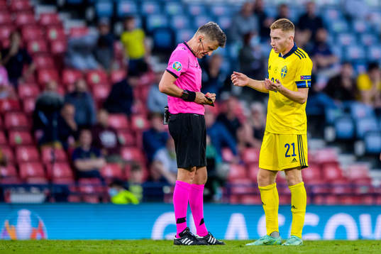 referee Daniele Orsato and Dejan Kulusevski of Sweden