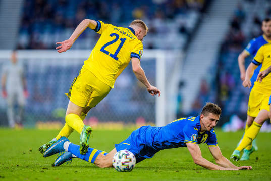 Dejan Kulusevski of Sweden and Illia Zabarnyi of Ukraine