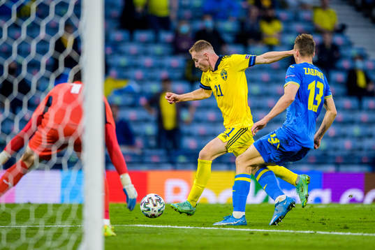 Dejan Kulusevski of Sweden and Illia Zabarnyi of Ukraine