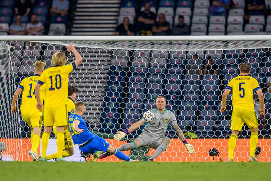 goalkeeper Robin Olsen of Sweden and Artem Dovbyk of Ukraine