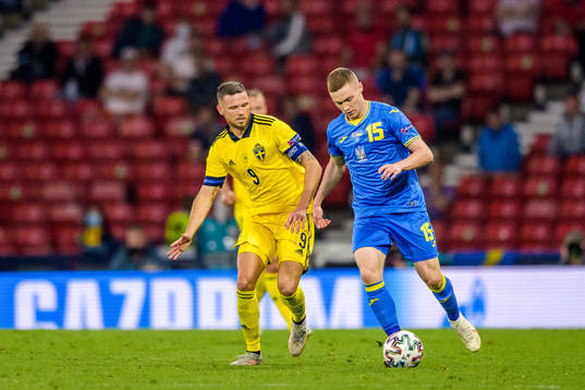 Marcus Berg of Sweden and Viktor Tsygankov of Ukraine