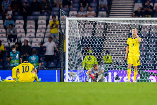 goalkeeper Robin Olsen and Filip Helander of Sweden looks