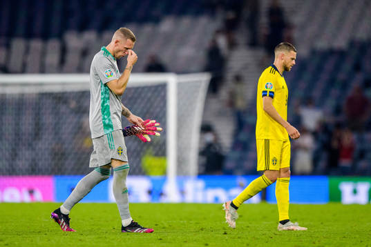 goalkeeper Robin Olsen and Marcus Berg of Sweden look