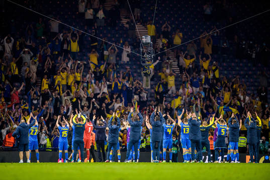 Players of Ukraine celebrate together with their supporters
