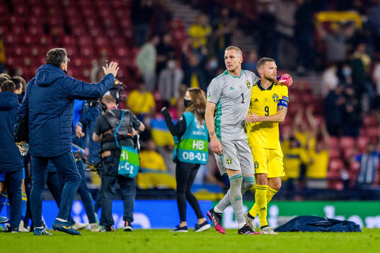 goalkeeper Robin Olsen and Marcus Berg of Sweden look