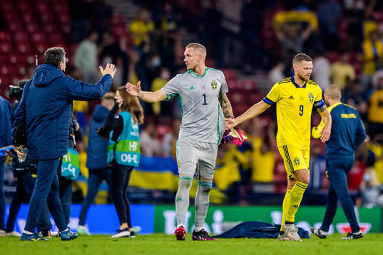 goalkeeper Robin Olsen and Marcus Berg of Sweden look