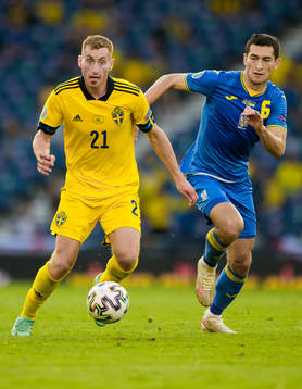 Dejan Kulusevski of Sweden and Taras Stepanenko of Ukraine