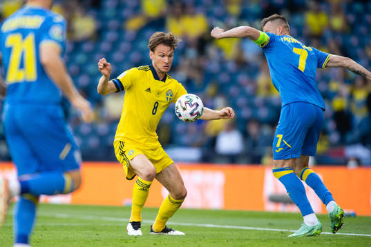 Albin Ekdal of Sweden and Andriy Yarmolenko of Ukraine